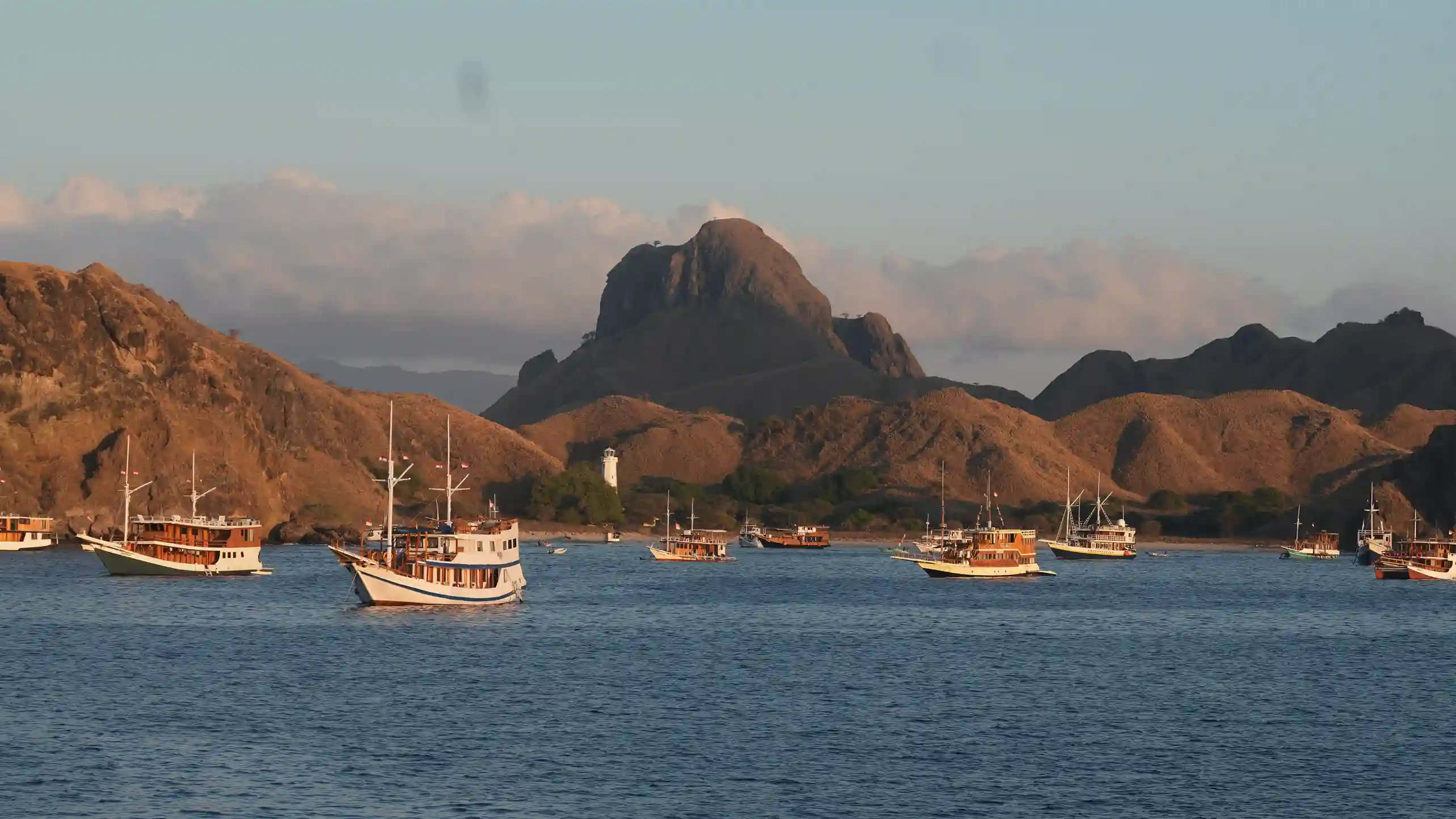 Boats moored in Komodo National Park at golden hour
