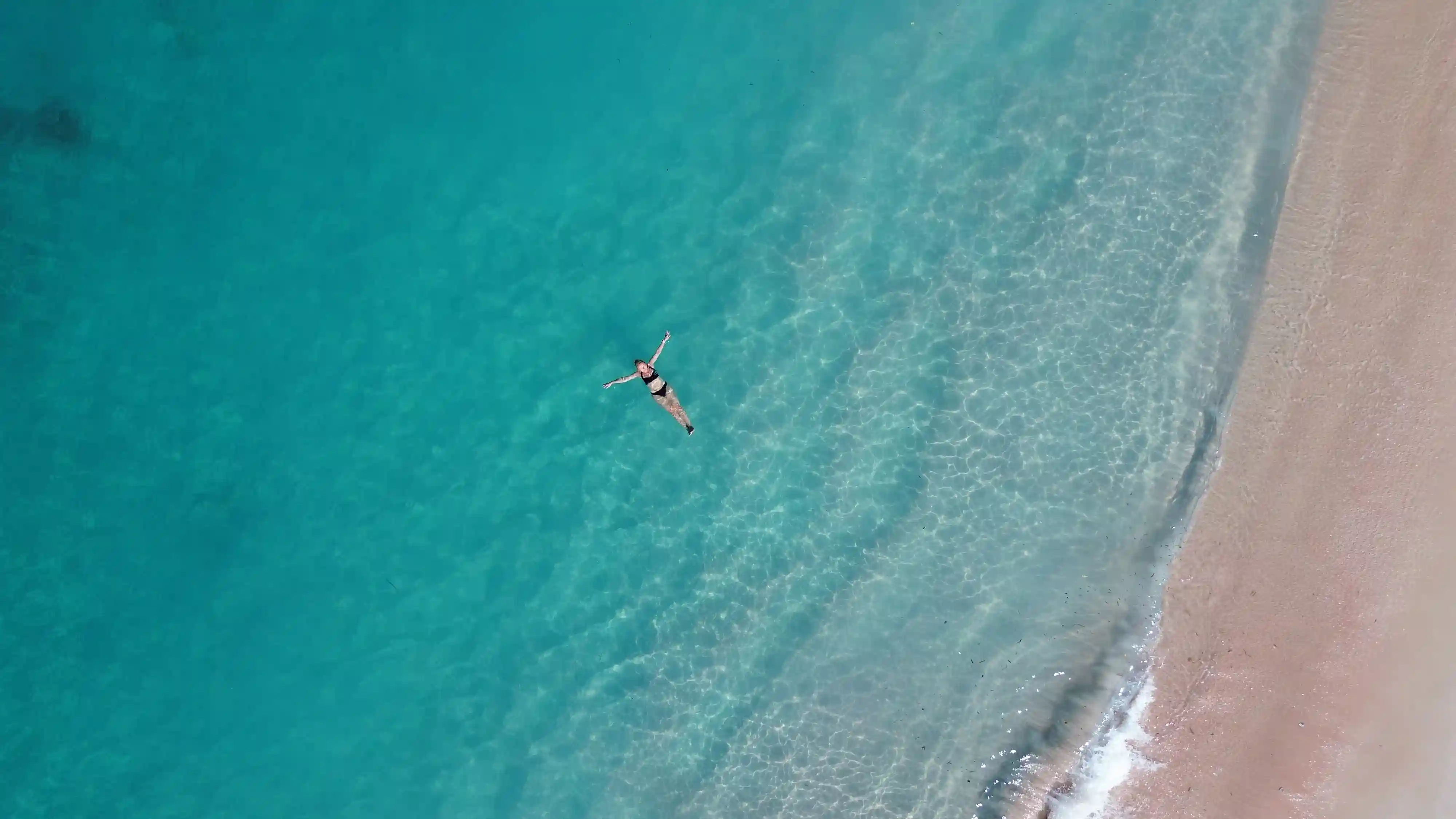 Snorkelers over vibrant coral just off Pink Beach