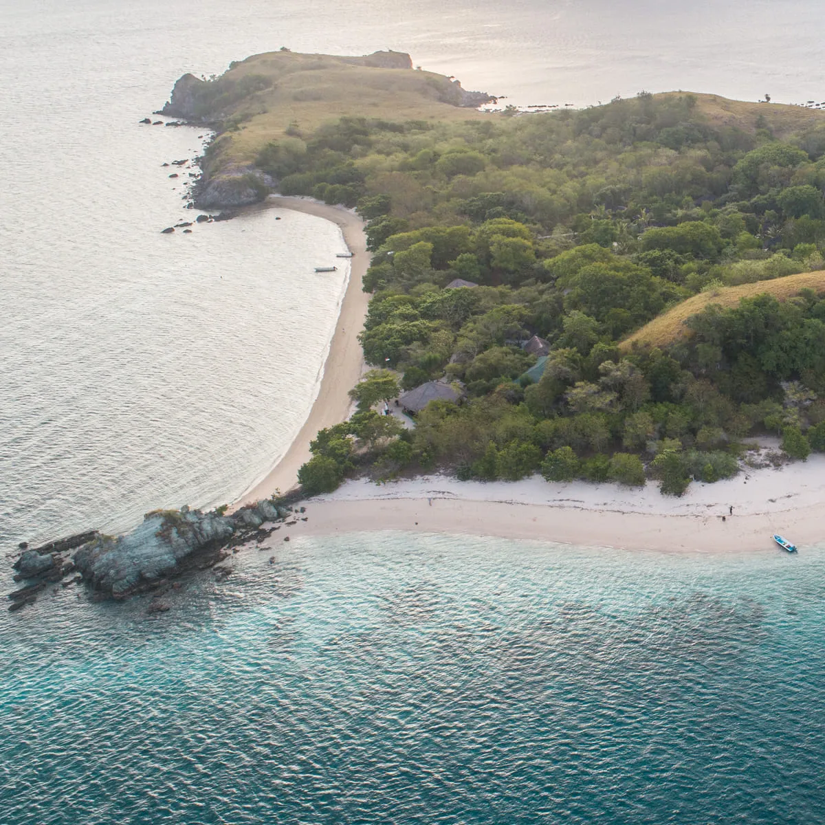 Snorkelers gliding over a vivid coral reef in Bidadari Island's crystal-clear water
