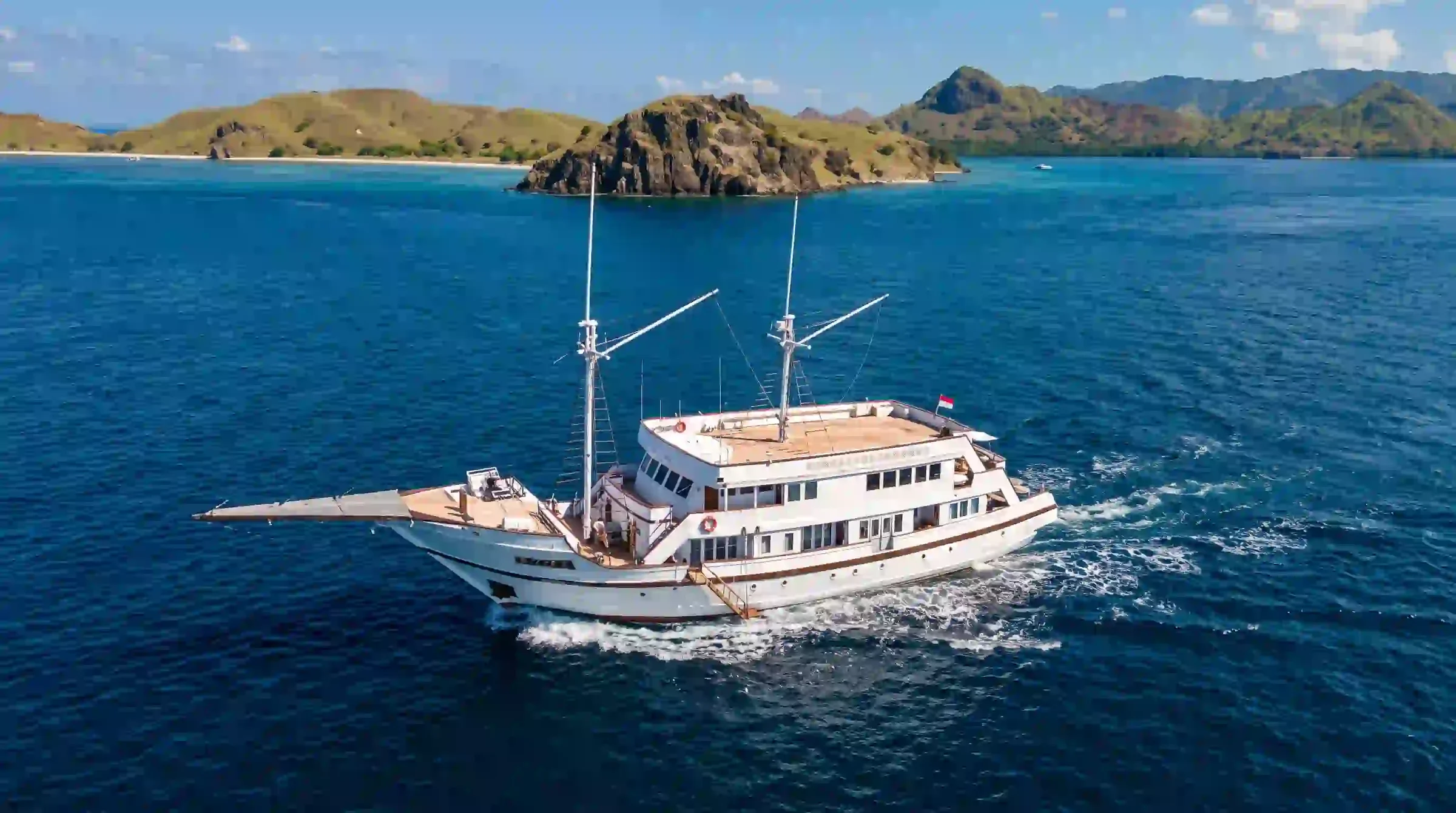 Aerial view of the 52.5-metre Lasha Phinisi Cruise cruising through Komodo waters