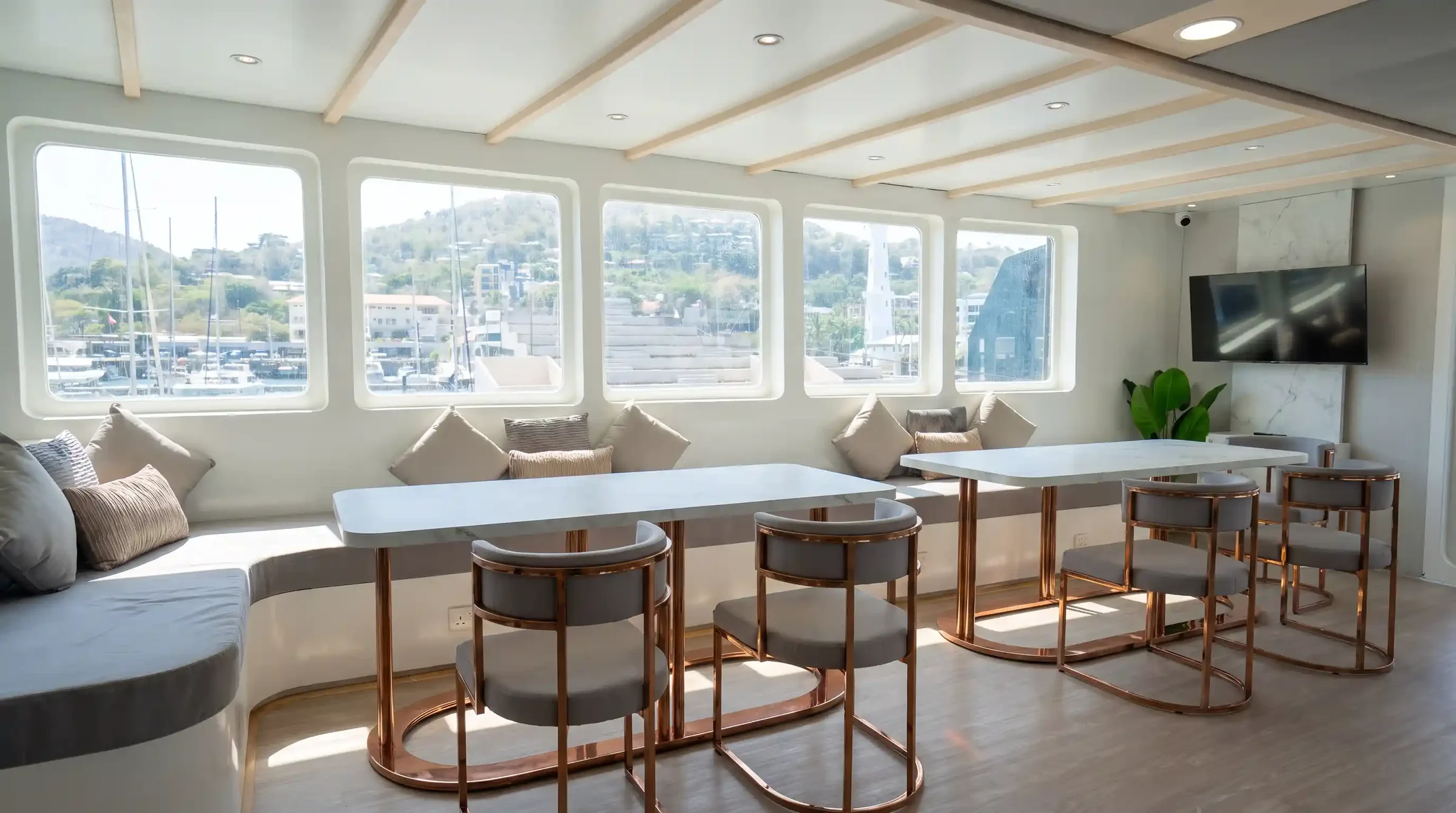 Air-conditioned indoor dining area on Lasha Phinisi Cruise with panoramic windows
