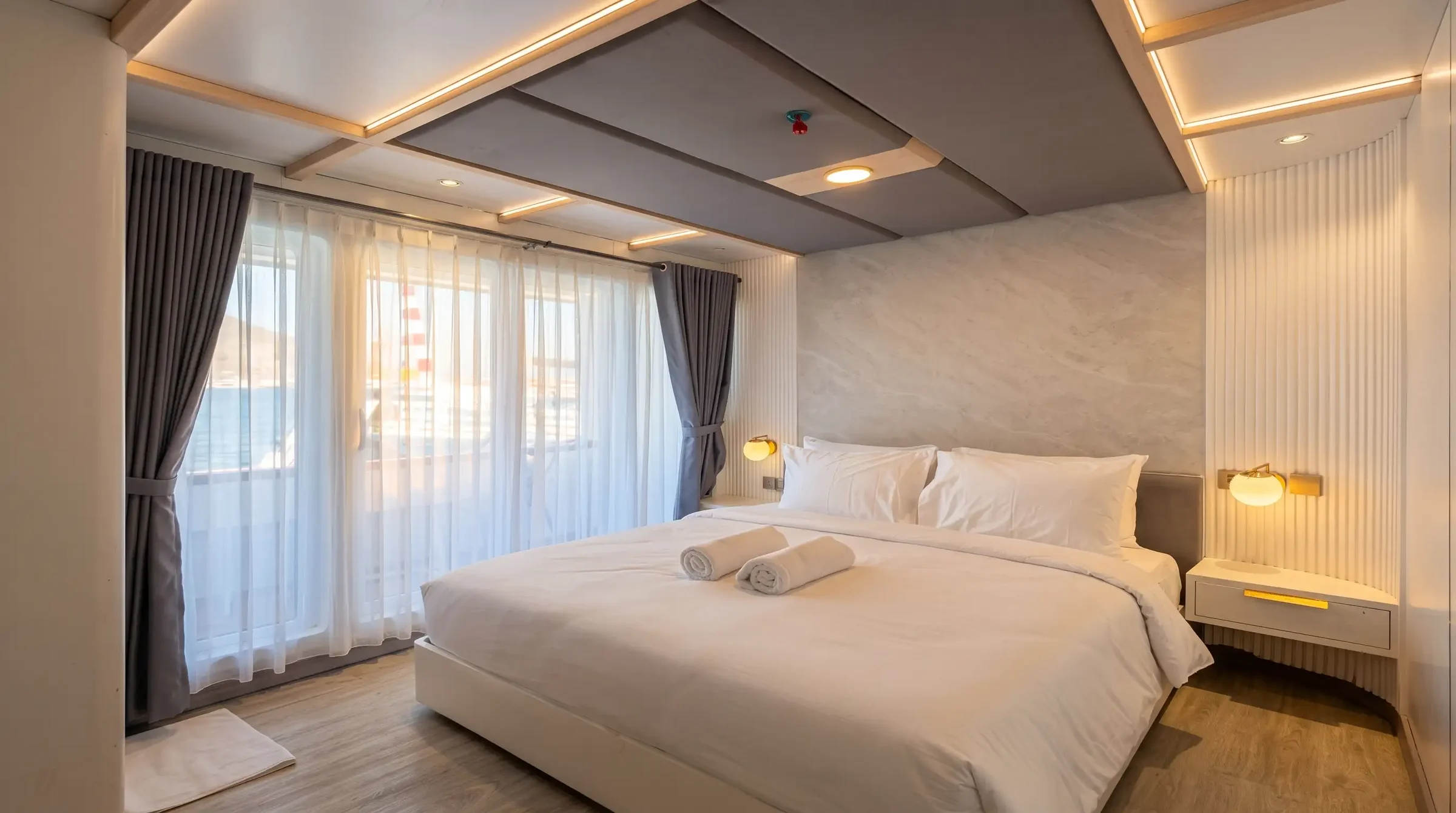 Junior Suite Balcony cabin on Lasha Phinisi Cruise with double bed and sea view