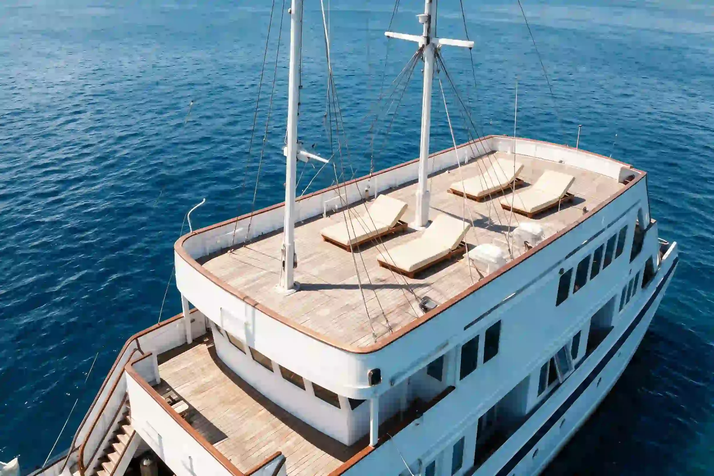Lasha Phinisi Cruise top-deck sun deck with teak loungers and a shared jacuzzi
